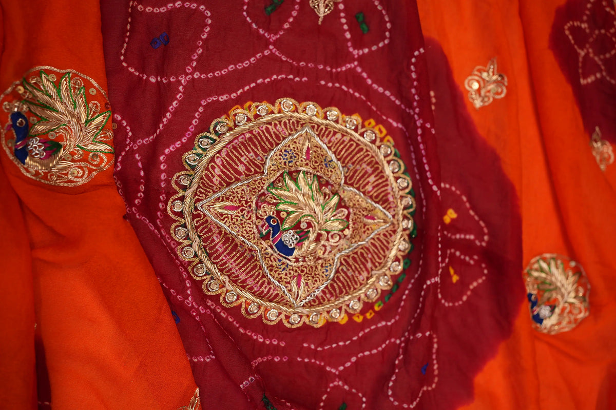 Detailed close-up of central circular Zardozi medallion featuring peacock motif embroidery