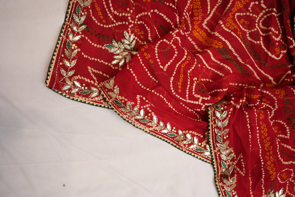 Draped section of Viscose Georgette Chunri showing leaf motif handwork and white Bandhej pattern