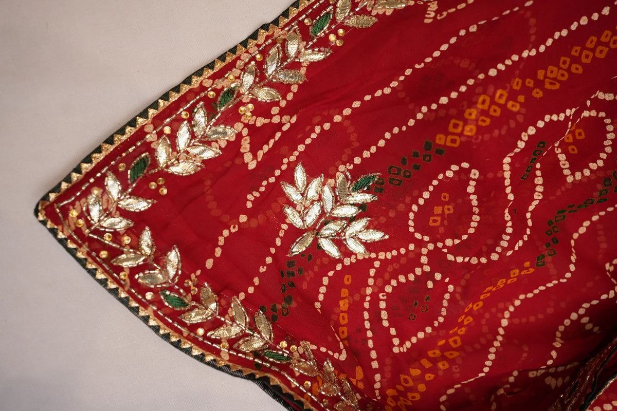 Corner detail of Red Viscose Georgette Shekhawati Bandhani Chunri displaying Gota Patti leaf border and Cut Dana work