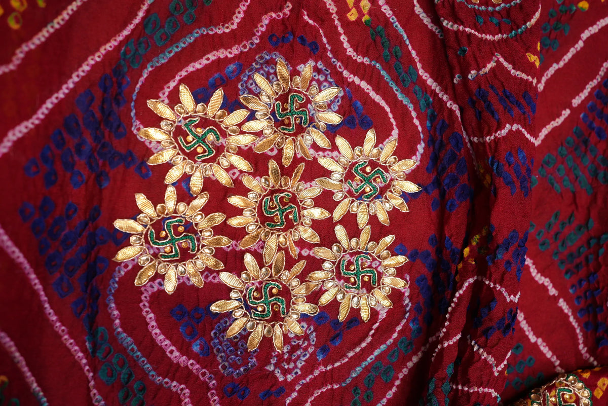 Close-up of central floral Gota Patti motif cluster featuring green Swastik embroidery