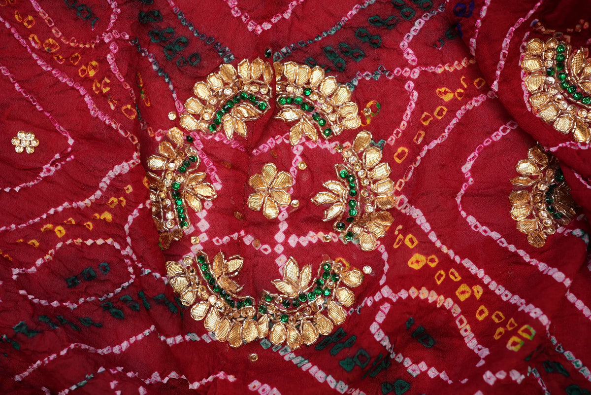 Close-up view of circular central Gota Patti motif surrounded by Cut Dana beadwork and green stones