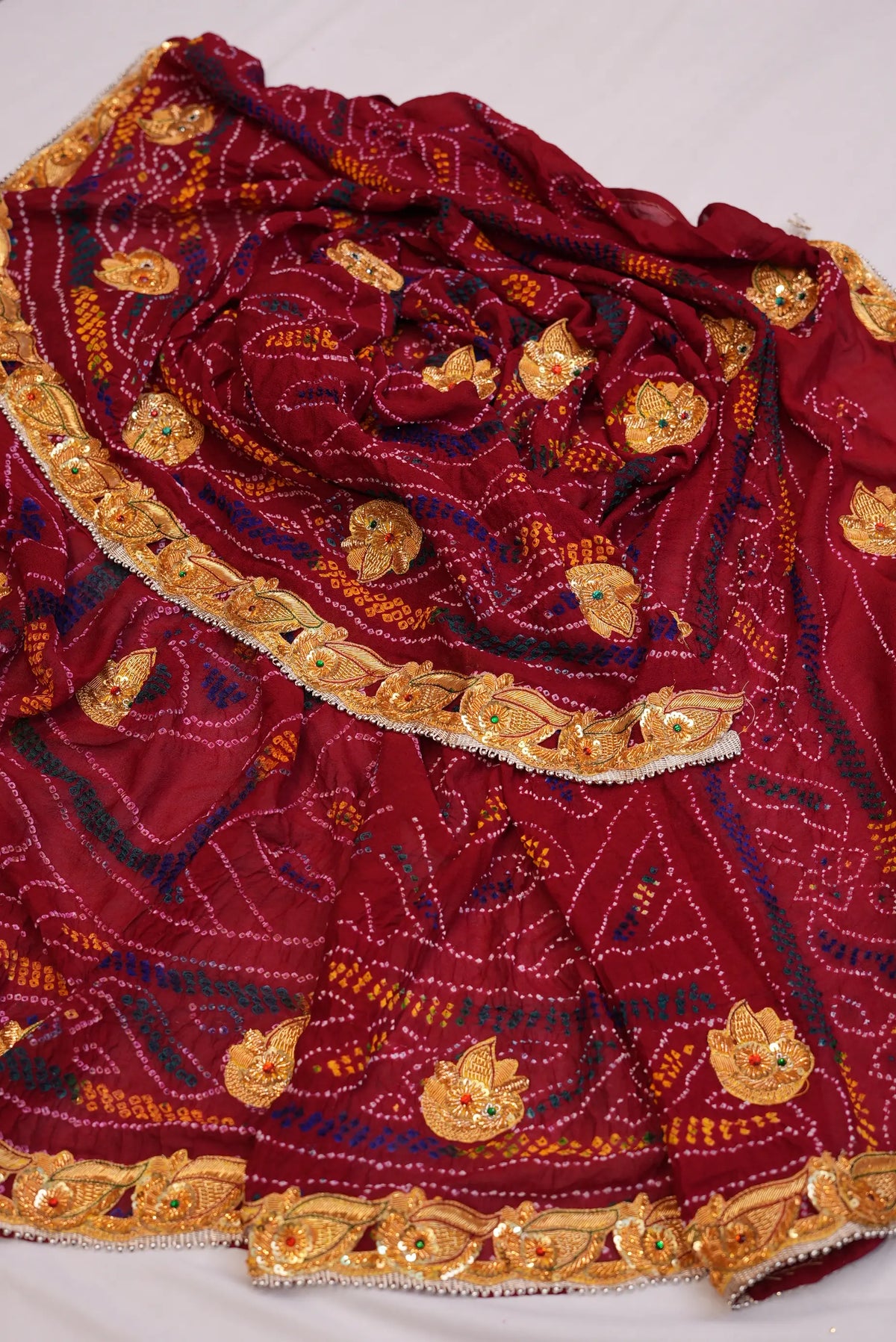 Full layout view of Maroon Ojariya Bandhani Dupatta with designer leaf border and handwork buttis