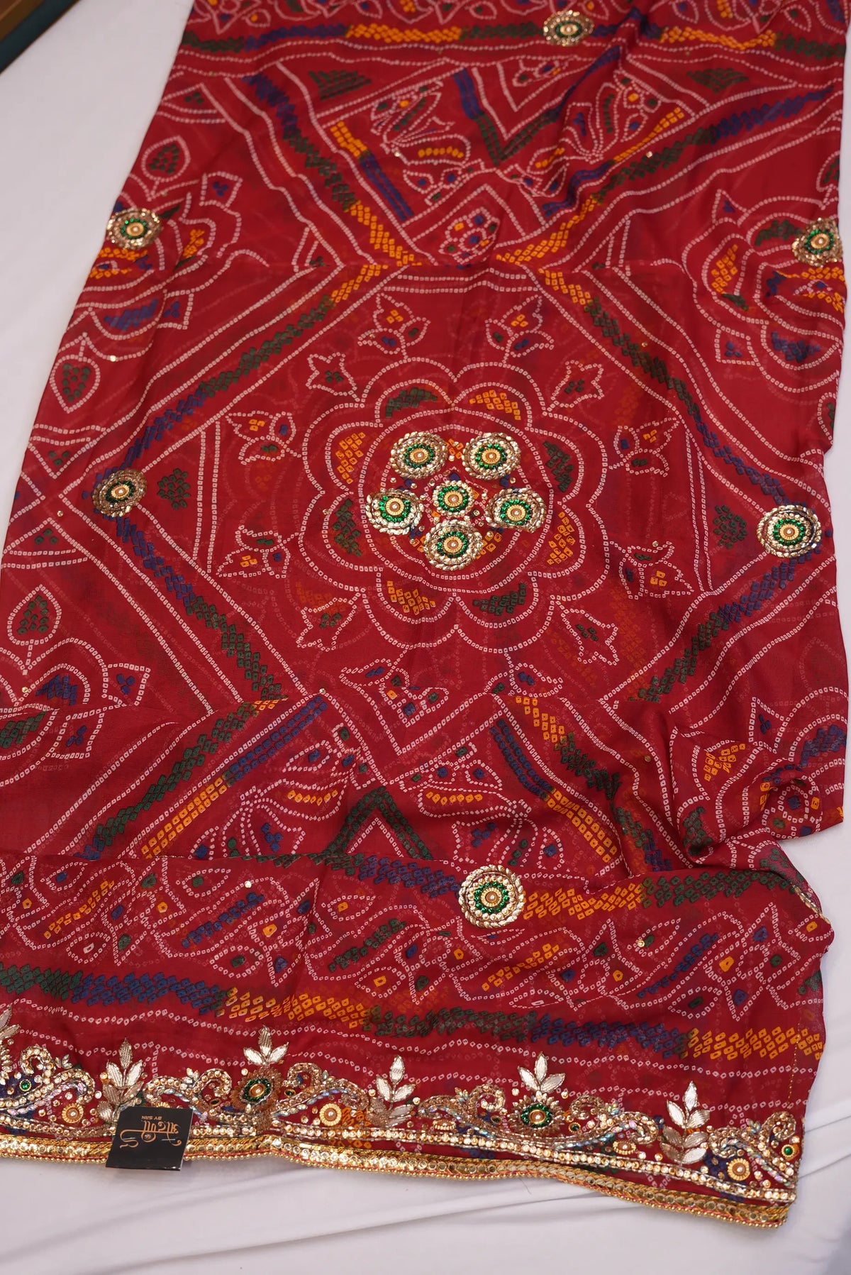 Flat lay of Shekhawati Bandhani Dupatta displaying rich Cut Dana handwork border with Odhani by SRN branding