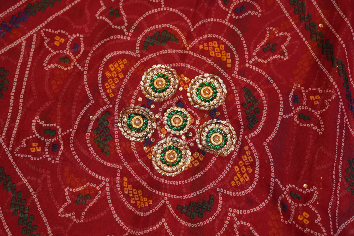 Detailed macro shot of circular flower medallion created with Cut Dana, beads, and green stone work