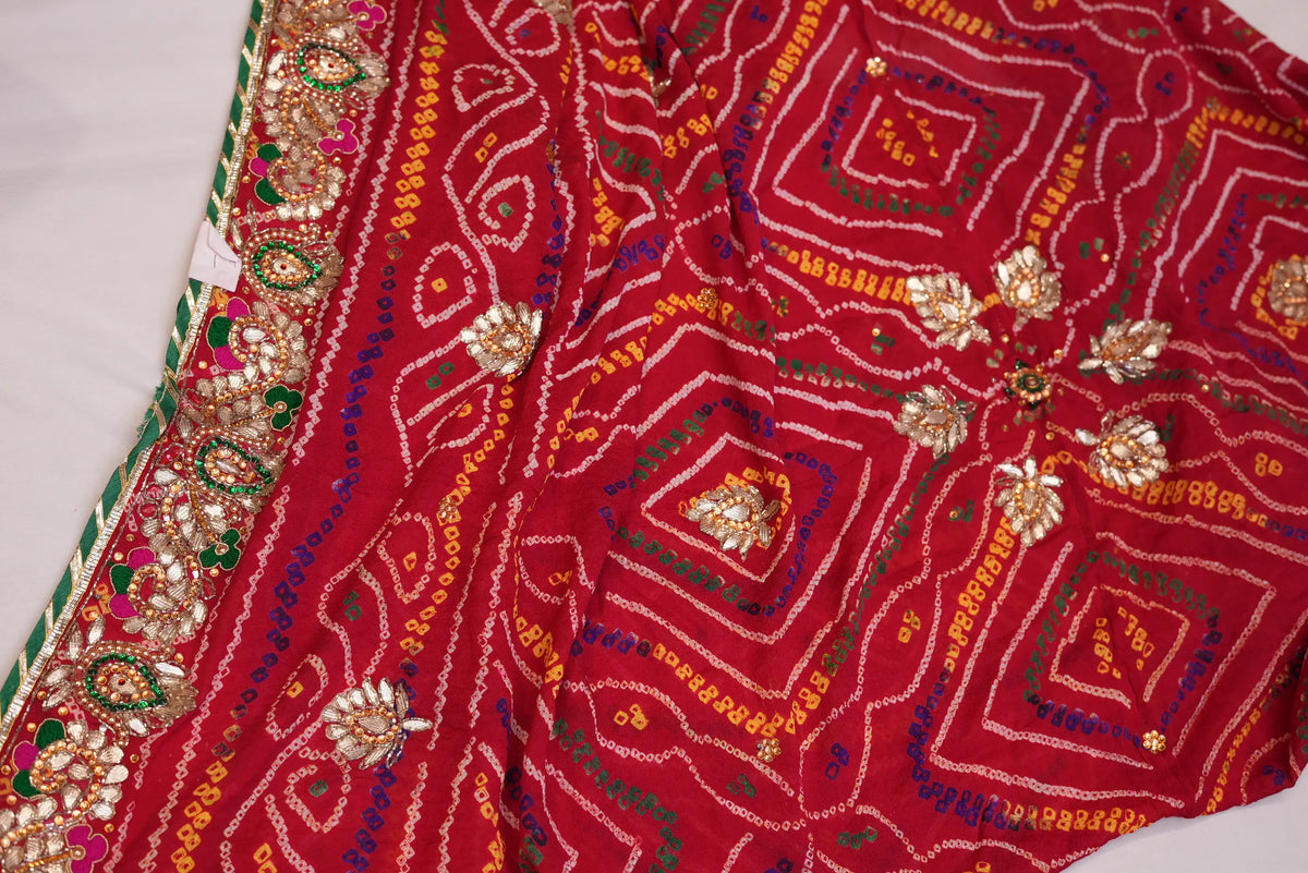 Top view of red Ojariya Bandhani Dupatta displaying geometric Bandhej prints and heavy handwork border