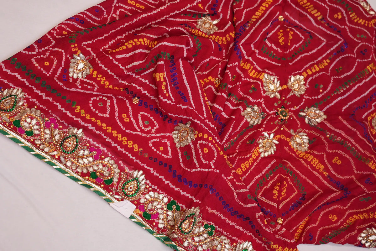 Spread layout of red Shekhawati Bandhani Chunri showcasing Gotta Patti body buttis and rich designer border