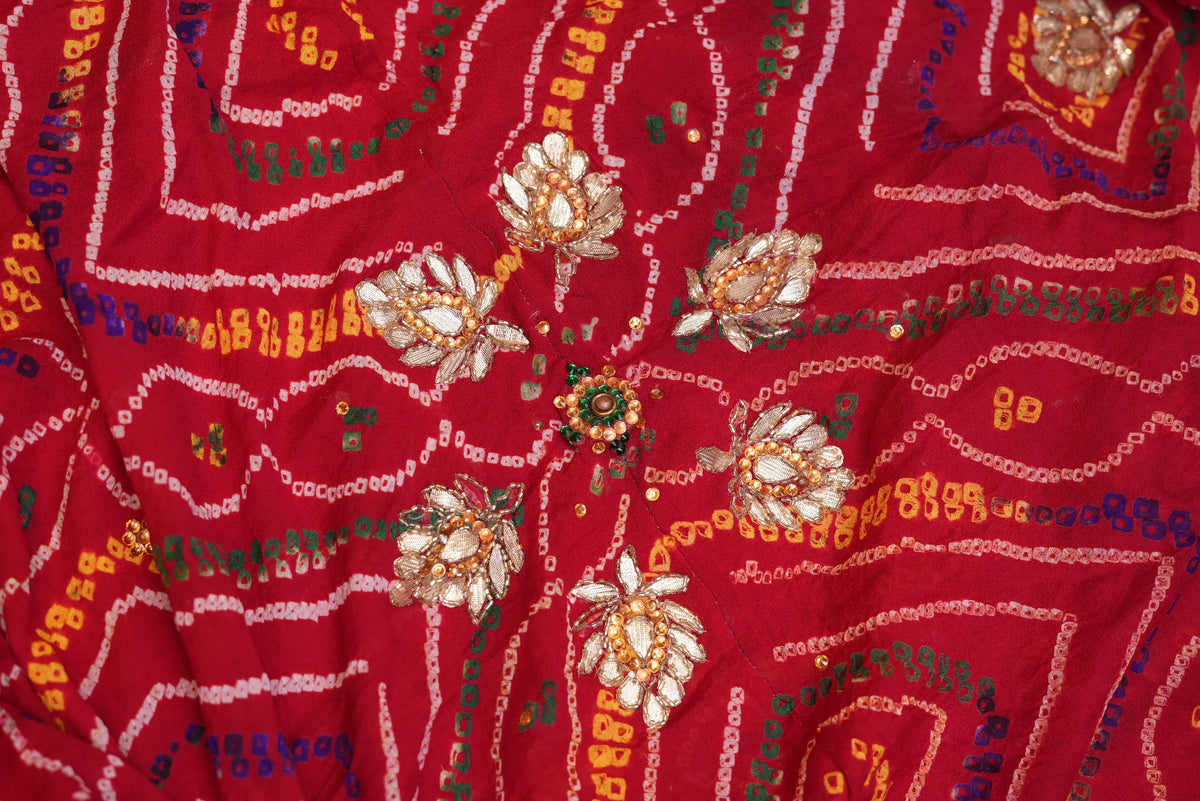 Detailed macro view of handcrafted silver Gotta Patti lotus flower motifs surrounded by Cut Dana embroidery