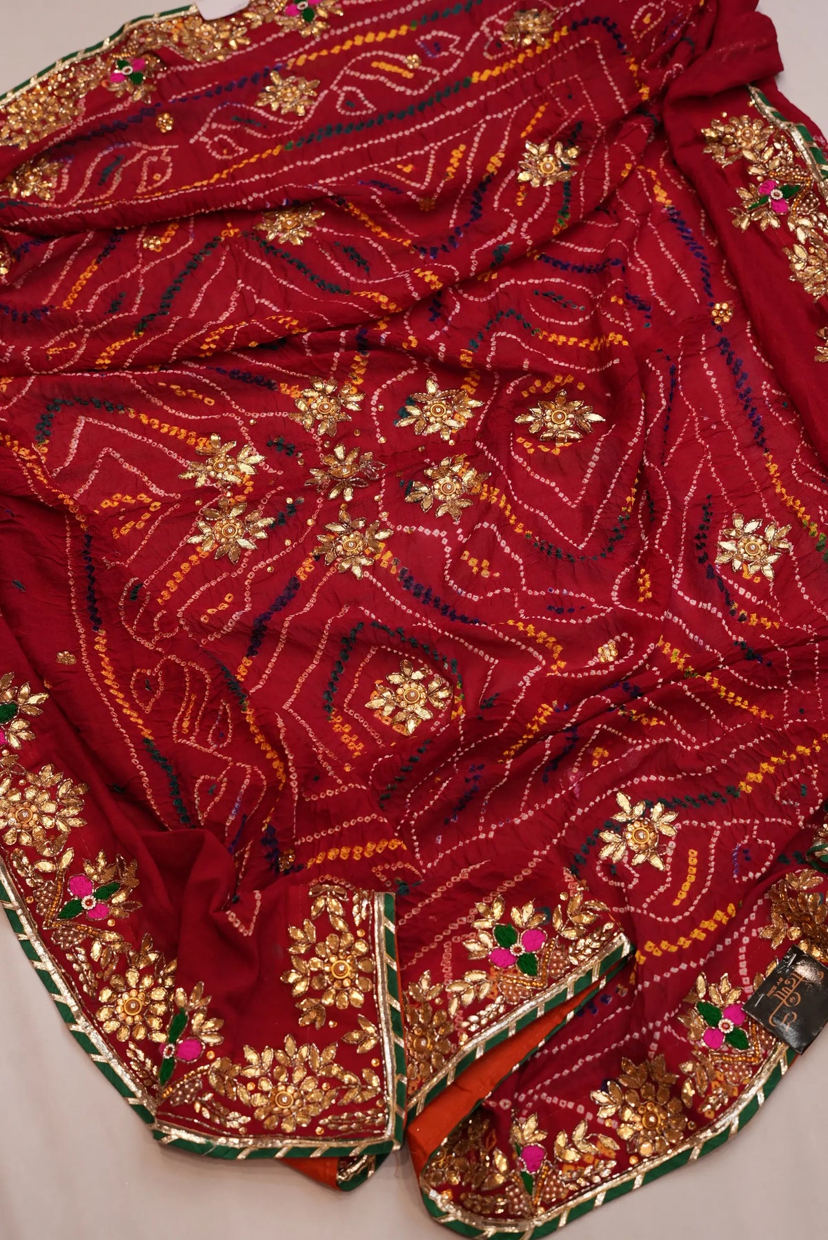 Full view of draped Maroon Pure Georgette Shekhawati Bandhani Chunri showcasing dense Zardozi buttis and border