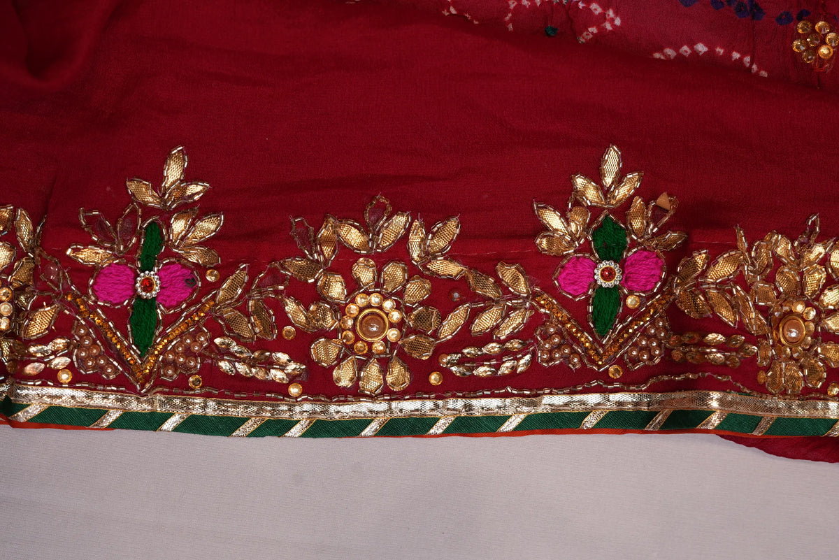 Detailed view of rich Zardozi and Resham embroidered border with green striped Magzi piping