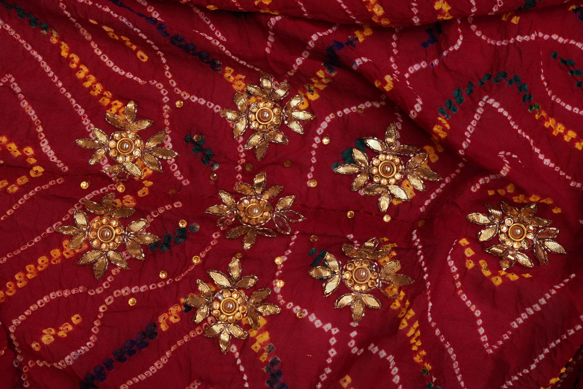 Close-up of all-over gold Zardozi flower buttis scattered across maroon Ojariya Bandhej Dupatta