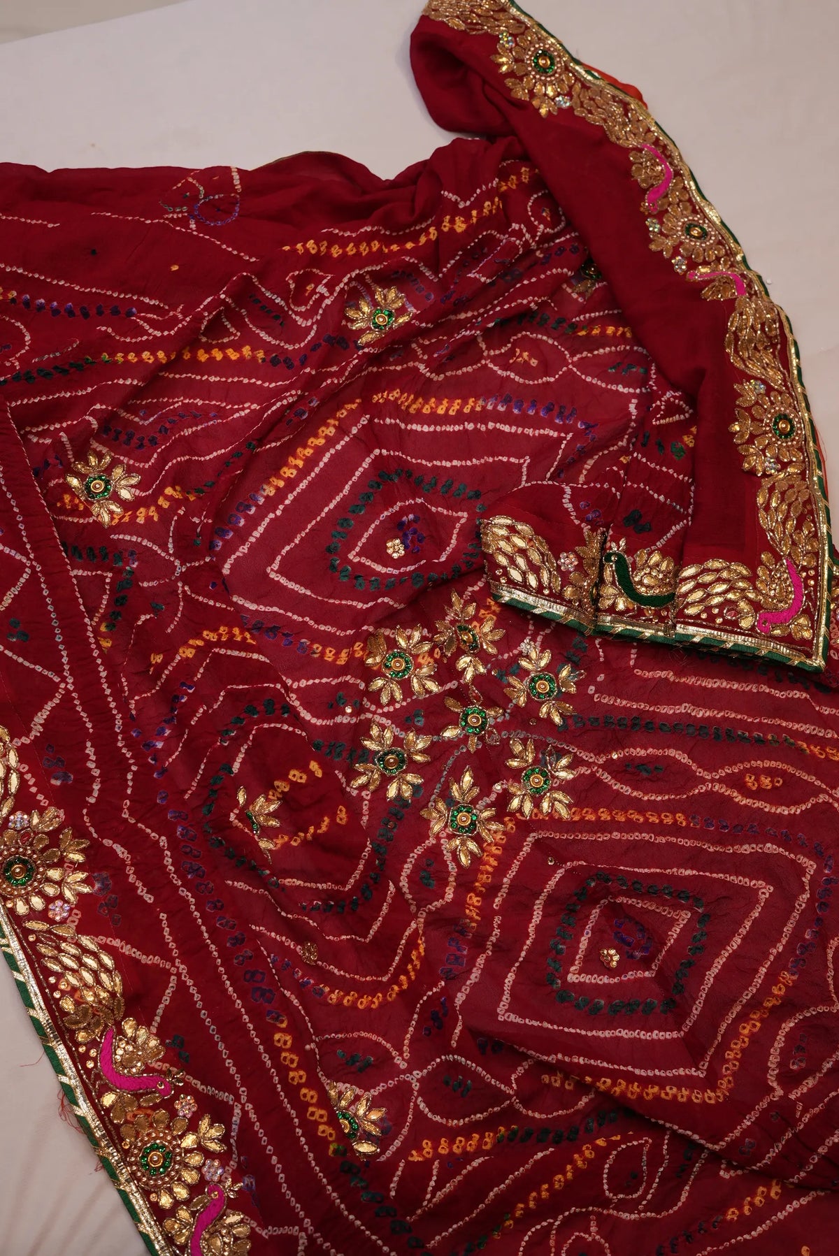Overview of Maroon Pure Georgette Shekhawati Bandhani Chunri showing gold Zardozi flower buttis and decorative border