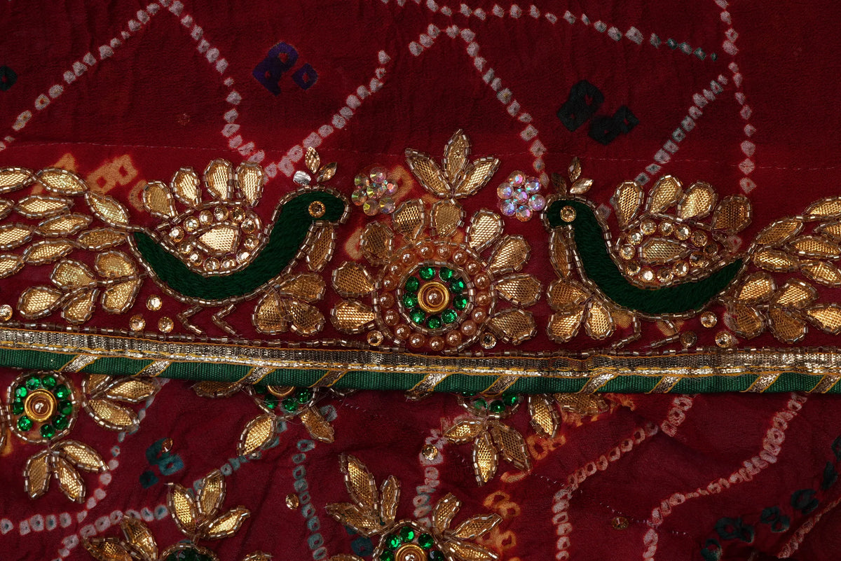 Close-up of forest-green Resham bird motif and floral Cut Dana work on dupatta border
