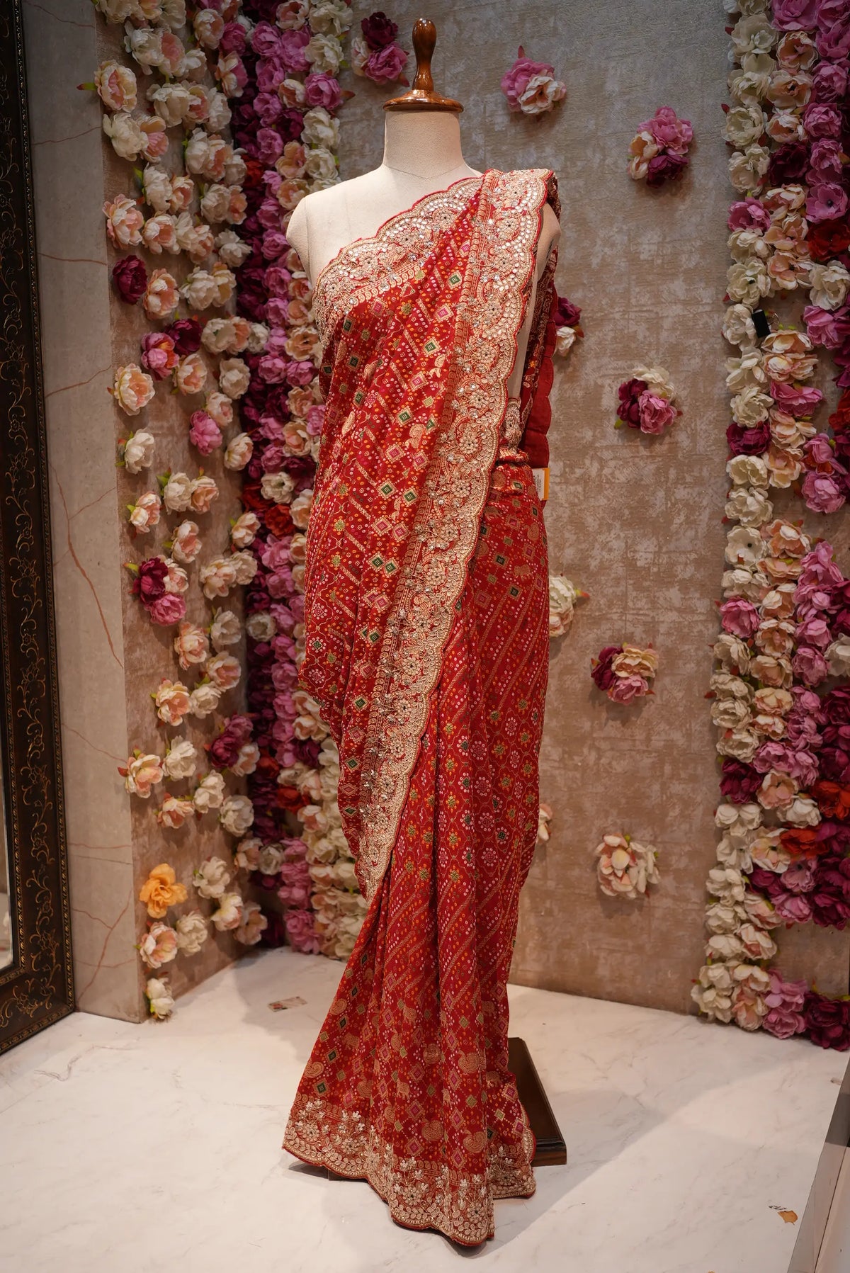 Full-length view of Red Pure Khaddi Georgette Bandhani Saree draped on mannequin with heavy scalloped zardozi border