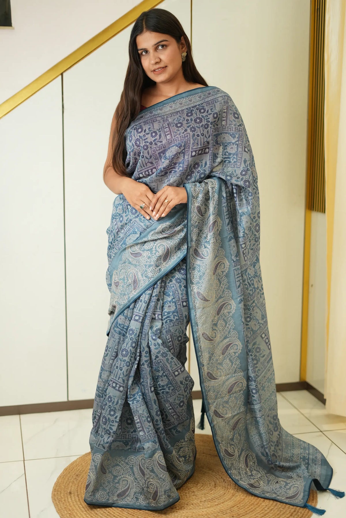 Model wearing slate blue cotton mix block print saree featuring floral geometric patterns