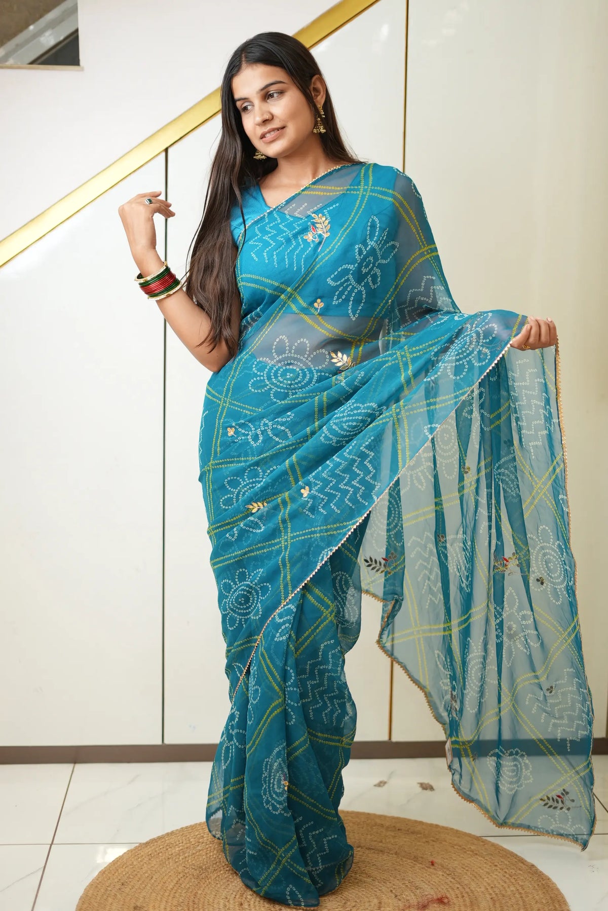 Teal blue chiffon bandhani saree featuring gota patti work and golden lace edging