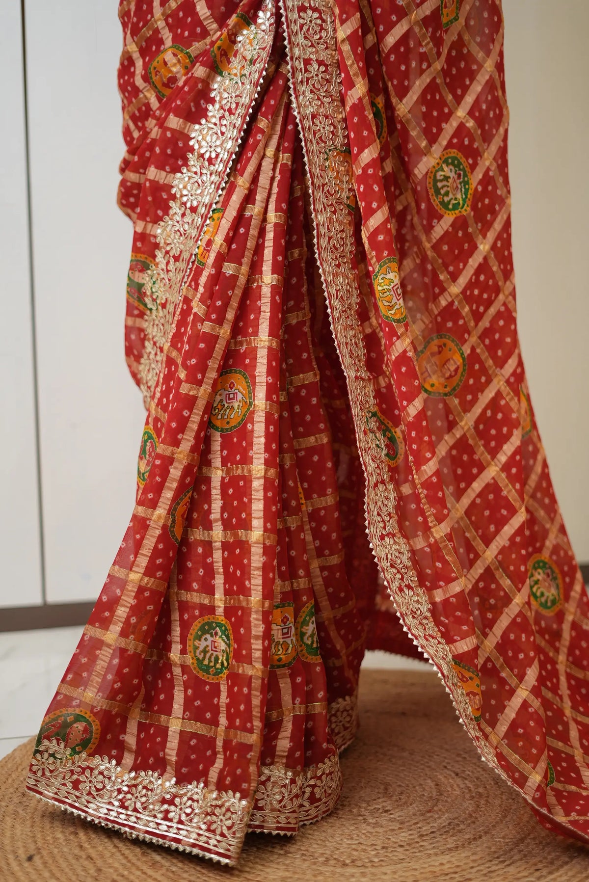 Pleat and pallu detail of red gajji silk bandhani saree showing elephant motifs and zari checks