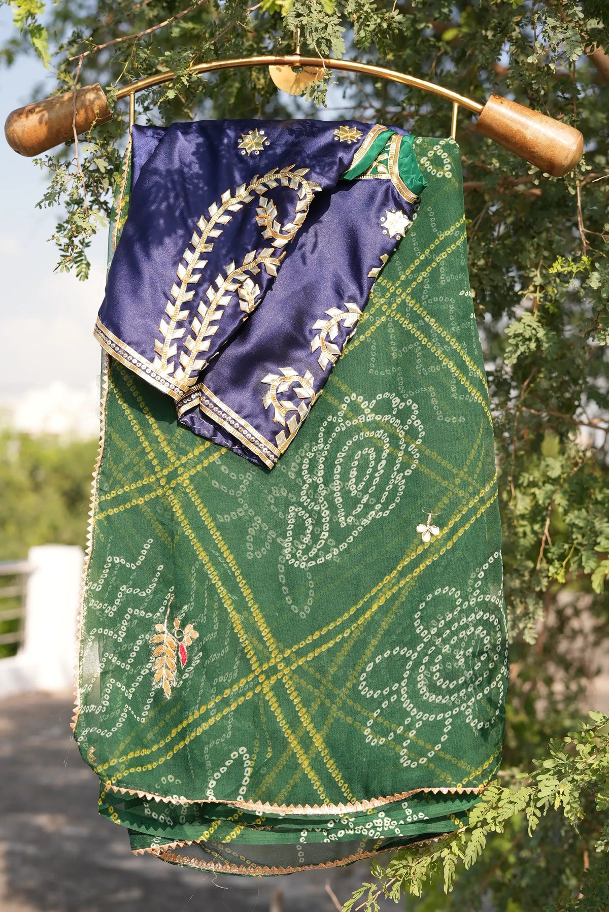 Front display of royal blue Rajasthani Aangi blouse featuring gold gota patti starbursts