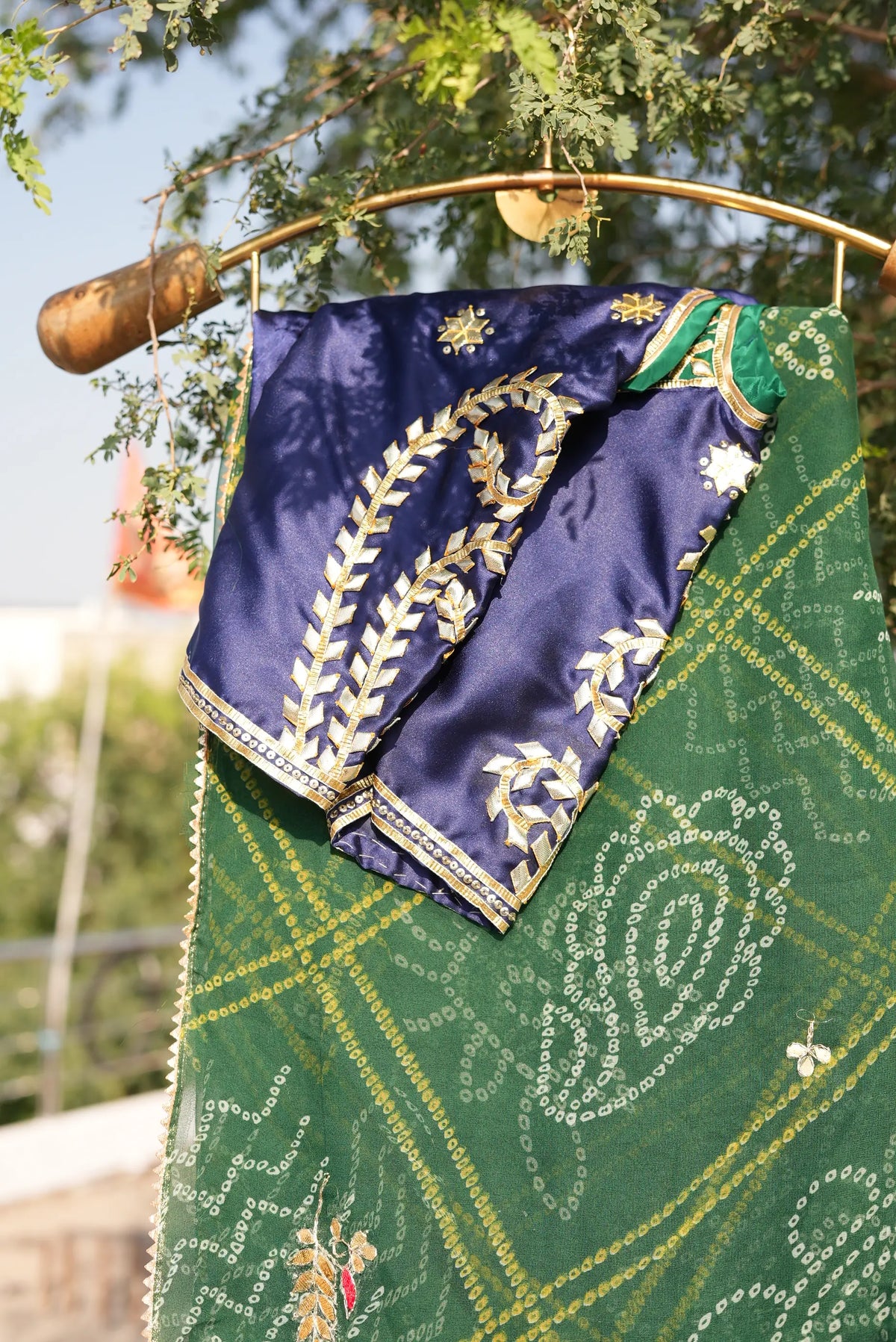 Close up shot of Tannu customized blue Aangi blouse with traditional gold lace detailing