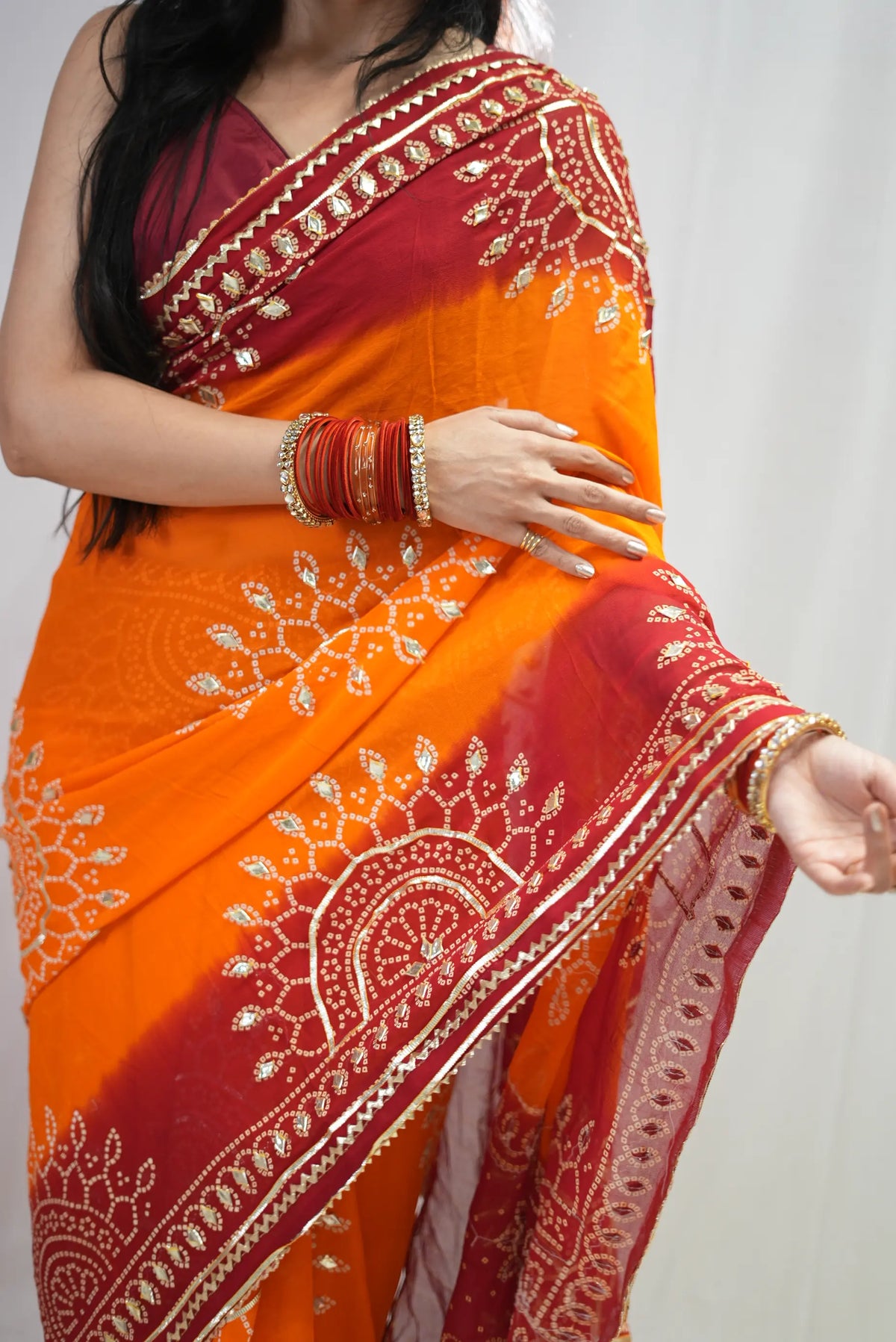 Close-up of circular gota patti motif and bandhej design on yellow georgette saree