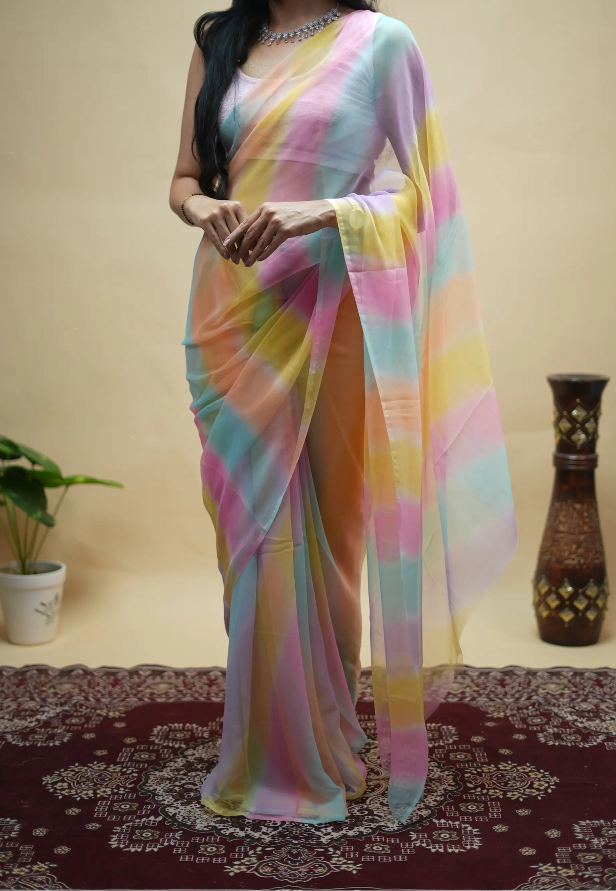 Full length pose of model draped in lightweight rajasthani multicolor leheriya georgette saree
