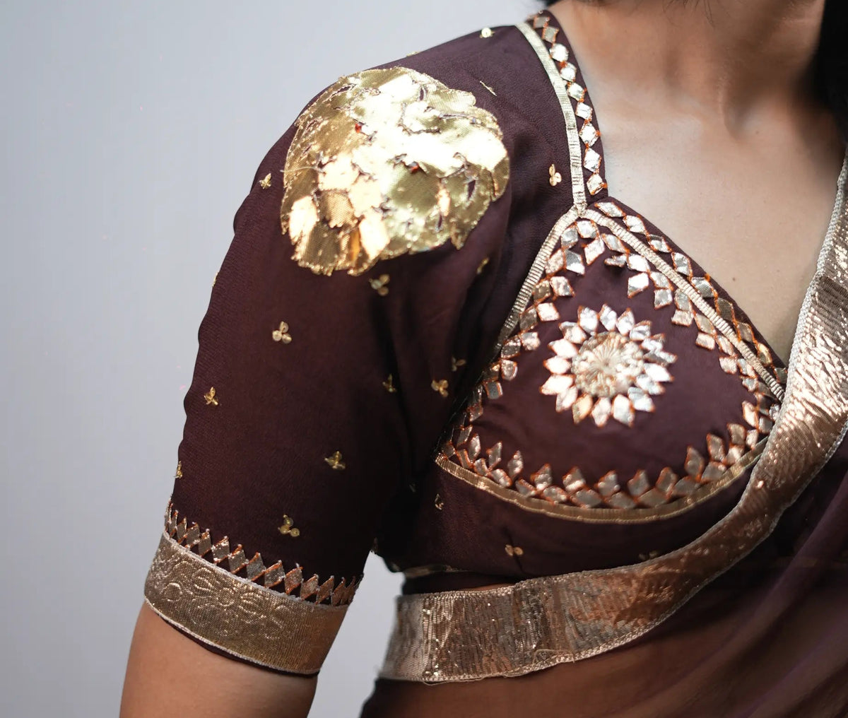 Detailed shot of Shakti Aangi Blouse displaying handcrafted gold lion motif on shoulder