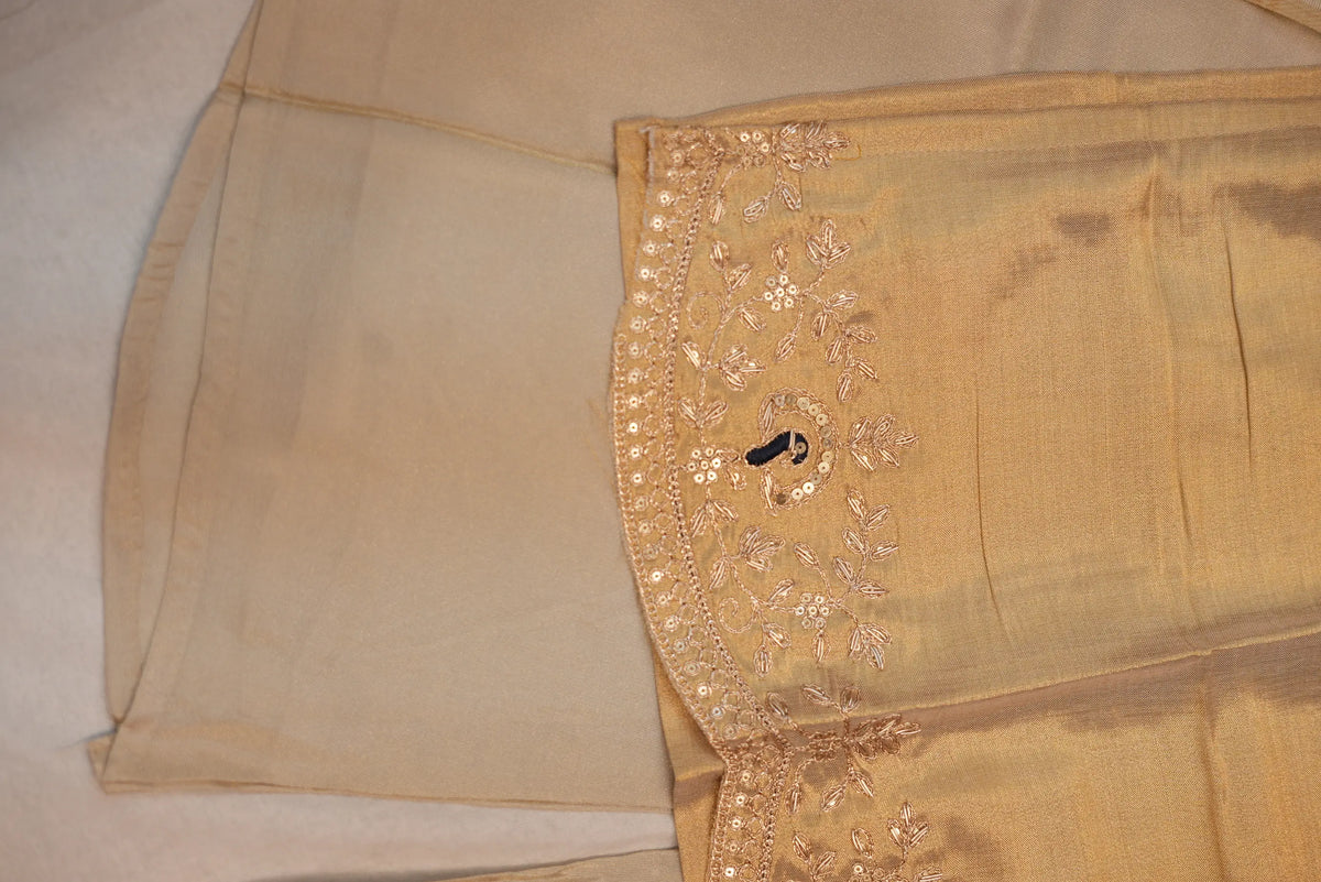 Close up view of embroidered hemline border on tissue short kurti