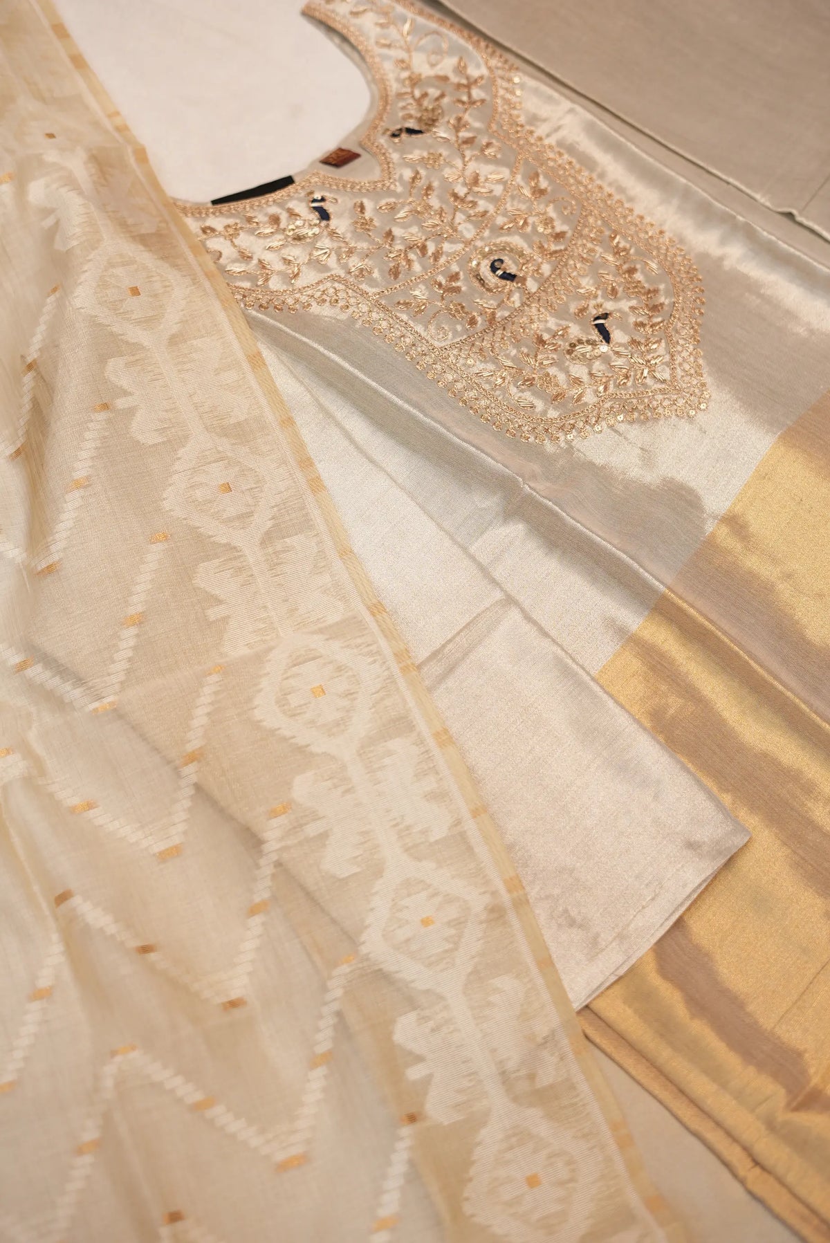 Side angle view of tissue short kurti with heavy zari woven dupatta