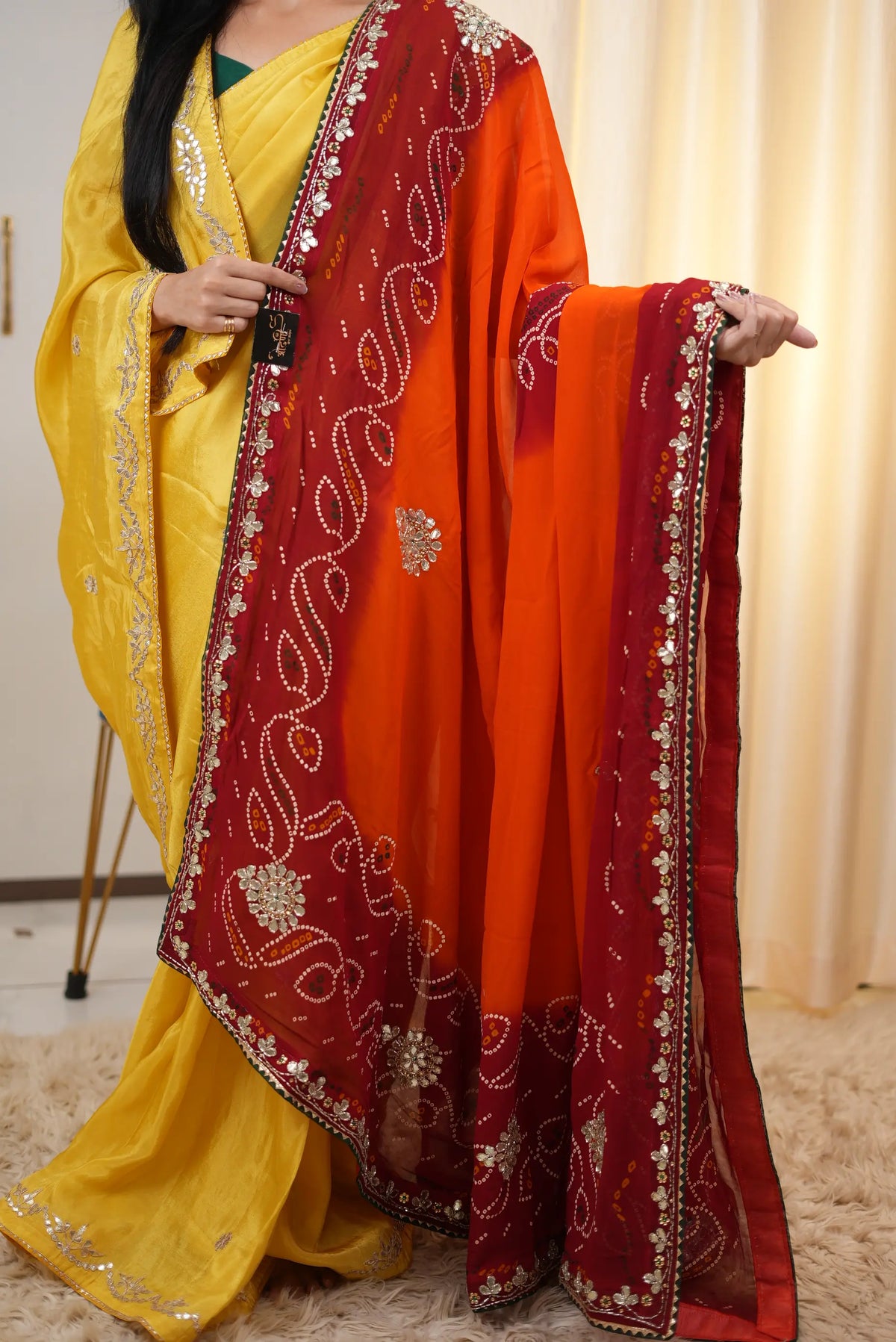 Full length view of orange red Shekhawati Pila dupatta draped over attire
