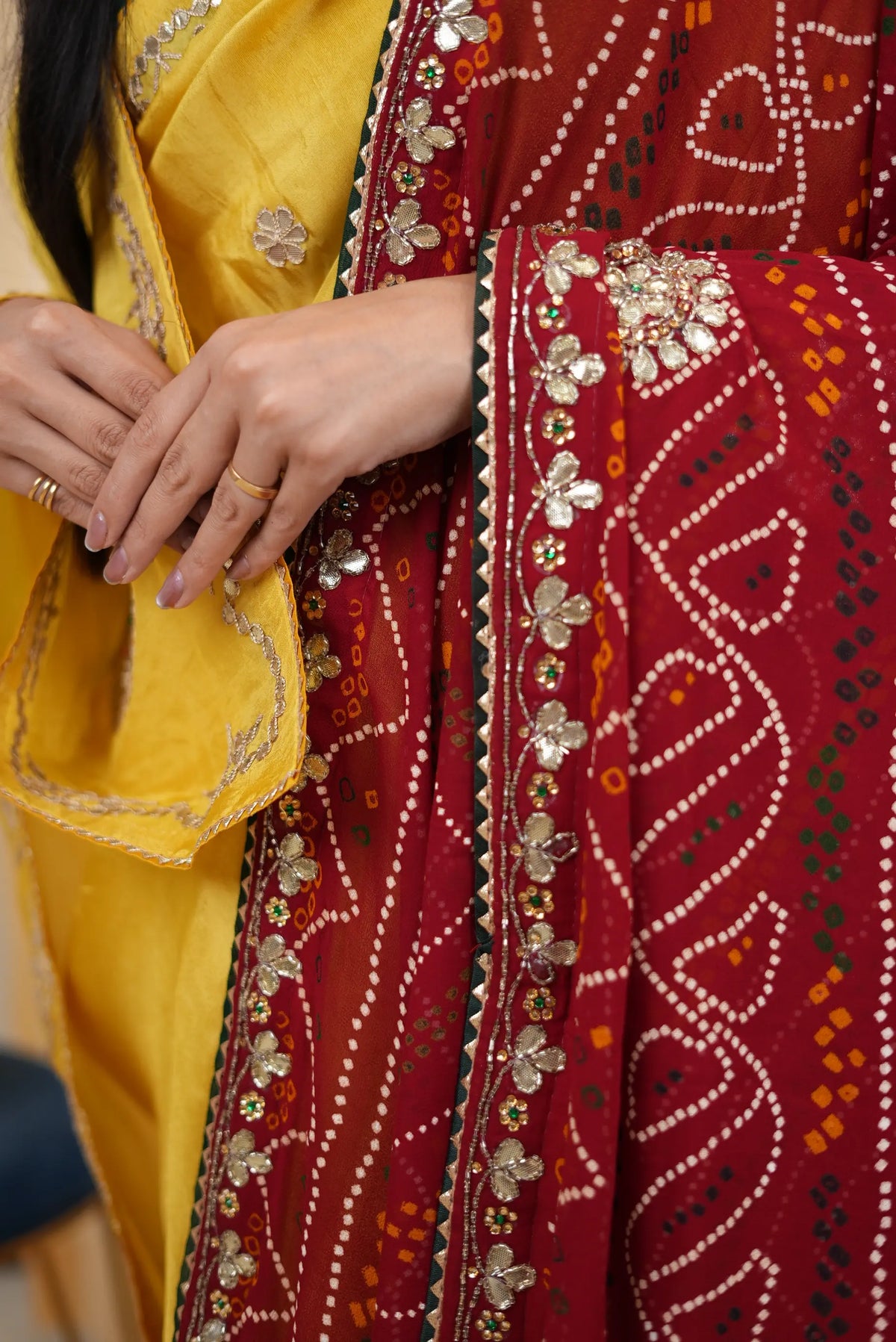 Detailed macro shot of Cut Dana and Gota Patti border work on maroon dupatta