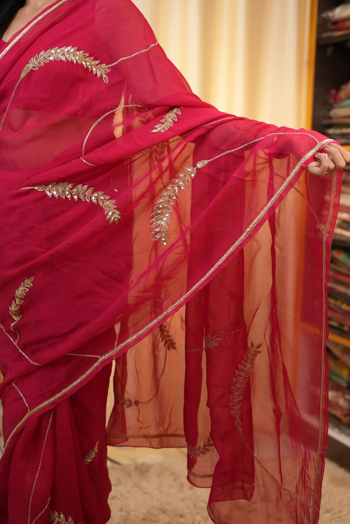 Detailed view of spread out pallu with sequins work and golden border finish