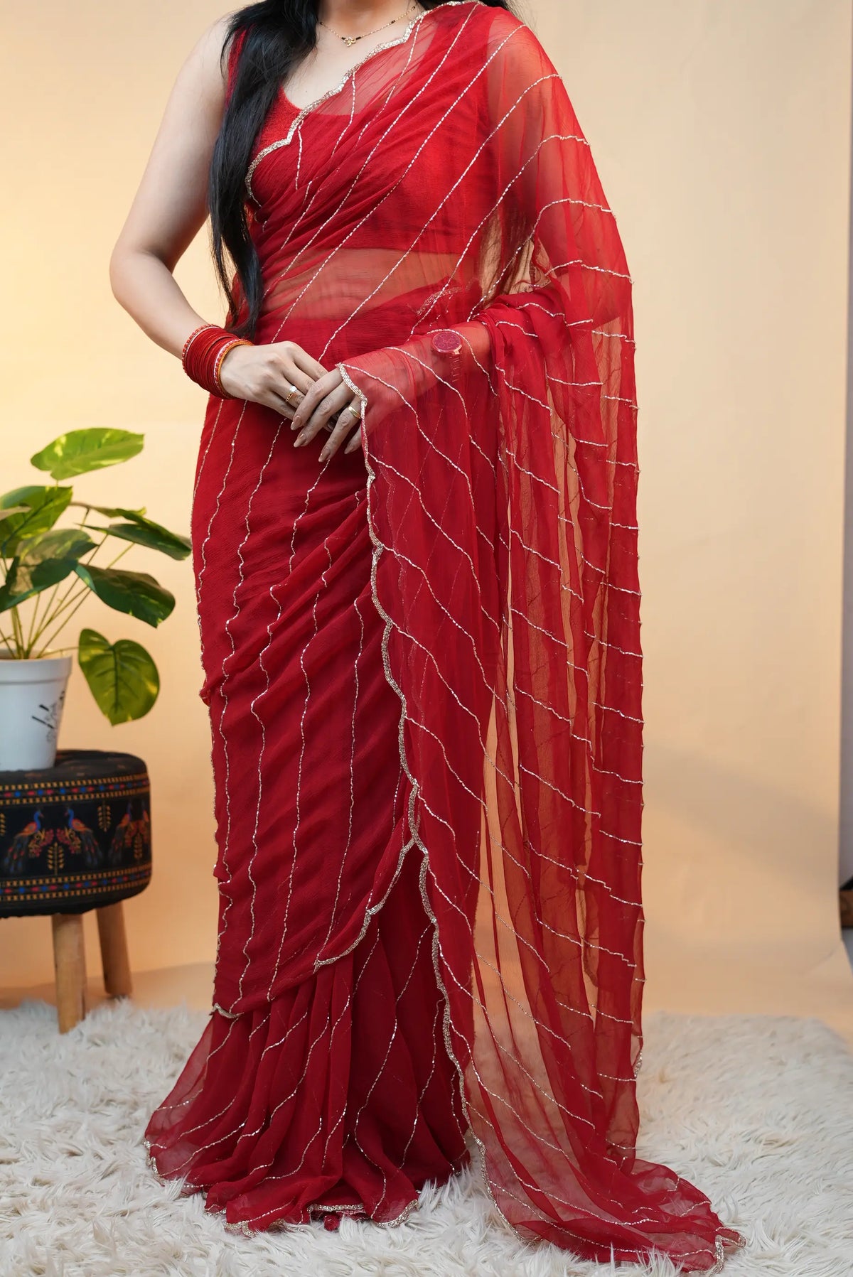 Full length posture view of model showcasing entire red pure chiffon saree drape with pallu