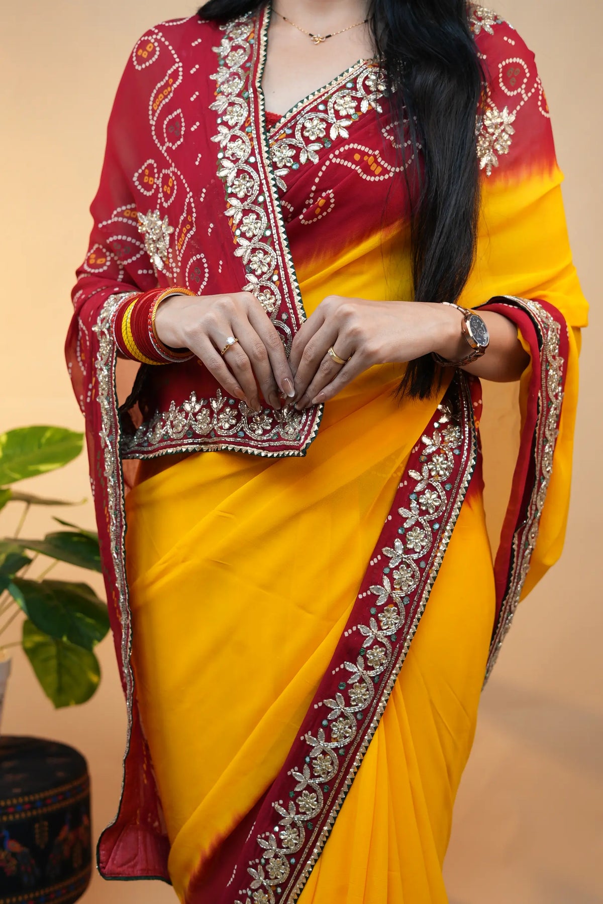 Front view of model draped in yellow and red Viscose Georgette Pila Pomcha saree with embellished blouse