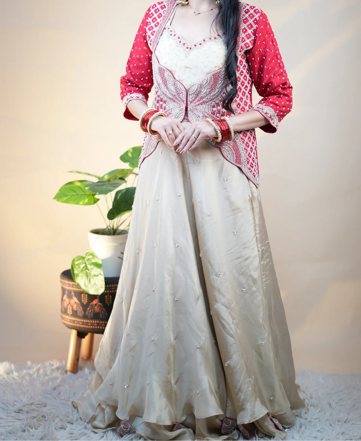 Full length posture of model showcasing complete 3-piece H.O. silk crop top, skirt, and red butterfly jacket set