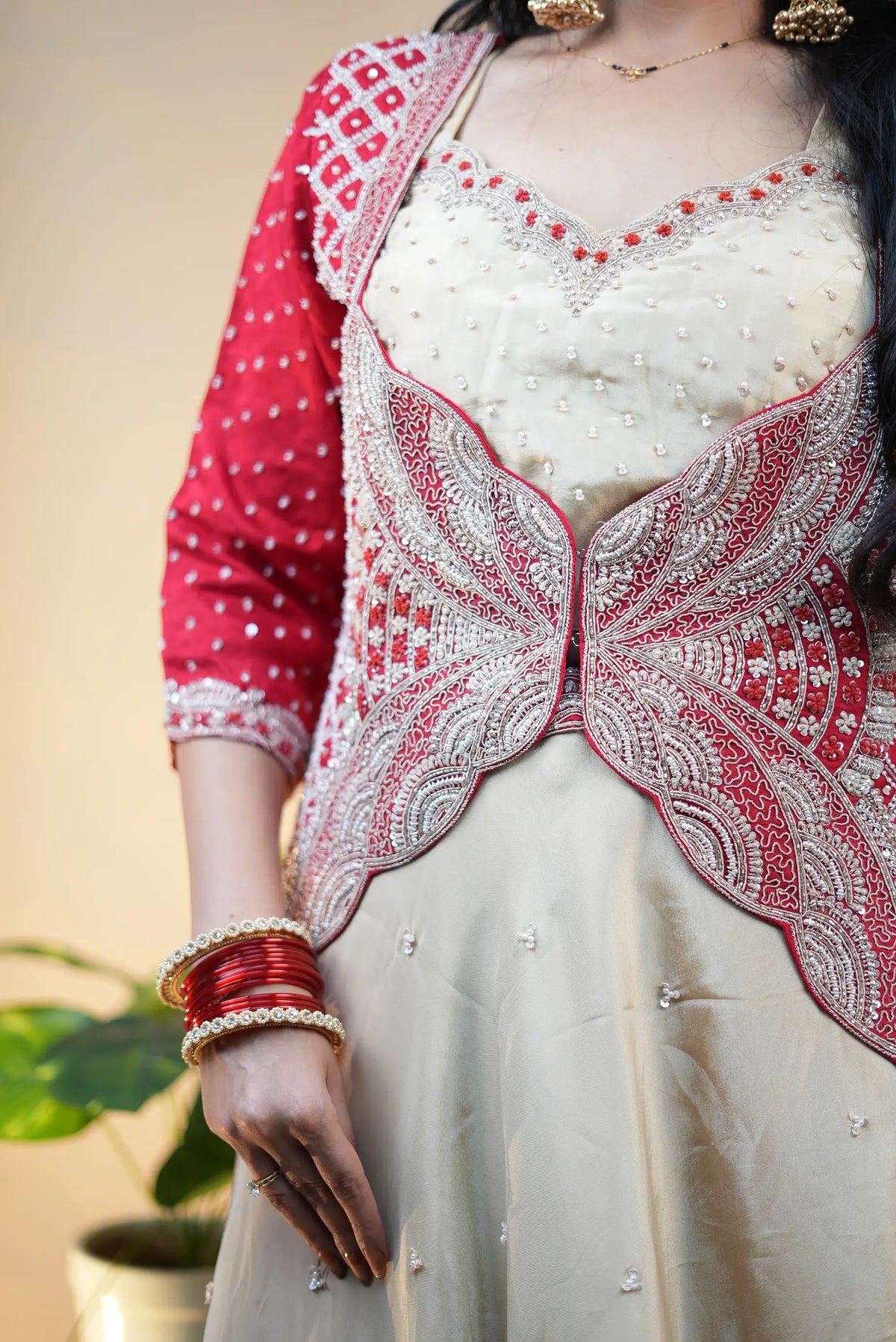 Front close-up pose showcasing butterfly front silhouette and pearl work on crop top and jacket