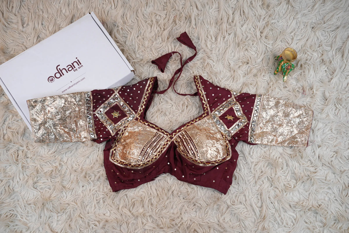 Full flat lay view of sample maroon and gold Gota Patti Aangi blouse alongside Odhani brand packaging