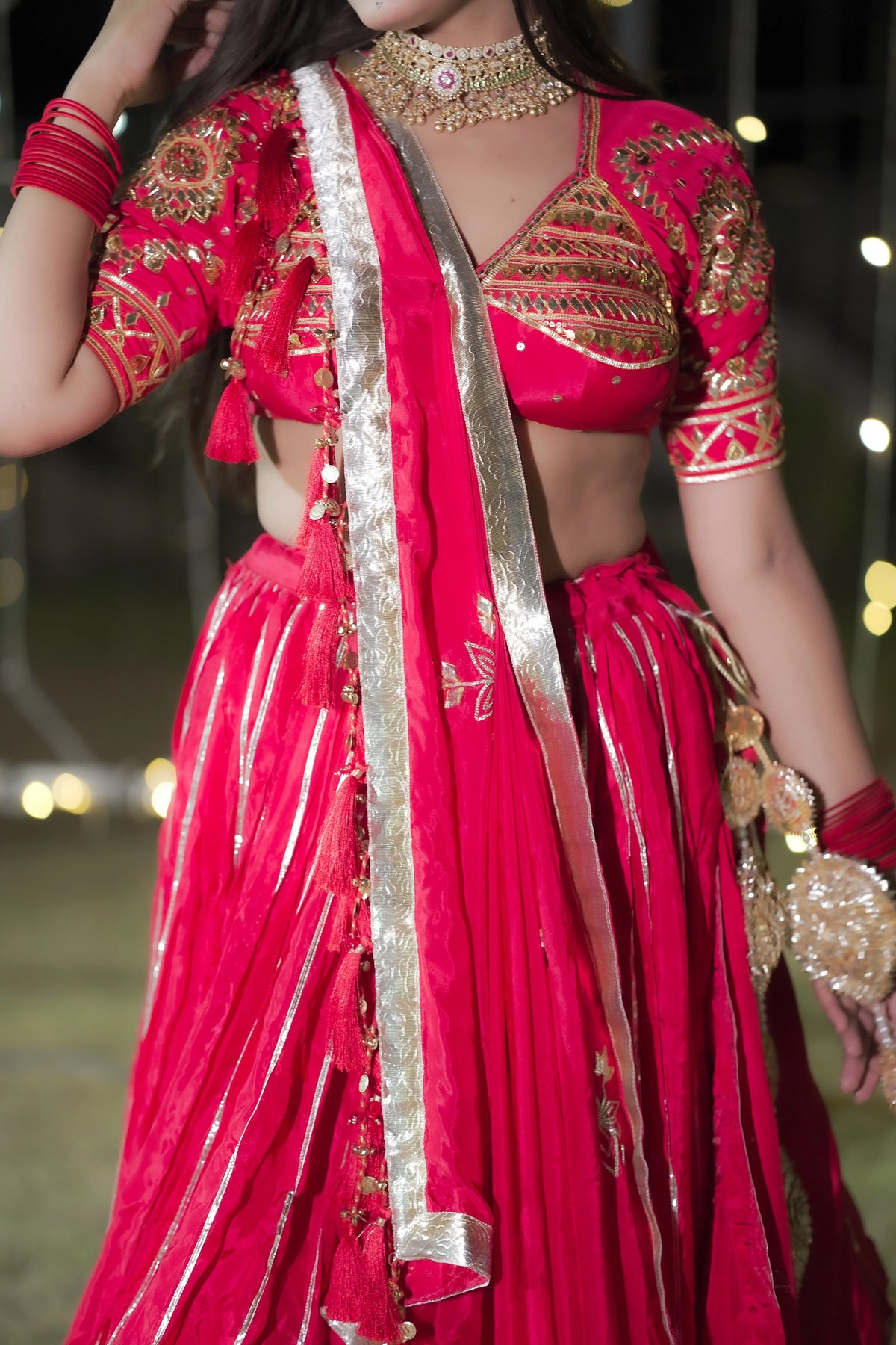 Mid shot showcasing waist flair and vertical lappa detailing on pure crepe red lehenga