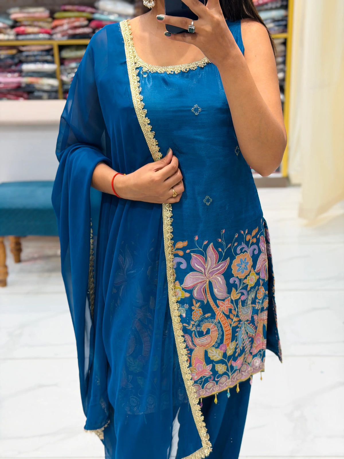 Mid-shot view showing golden lace border dupatta and floral brush paint daman on Peacock Blue Kurti