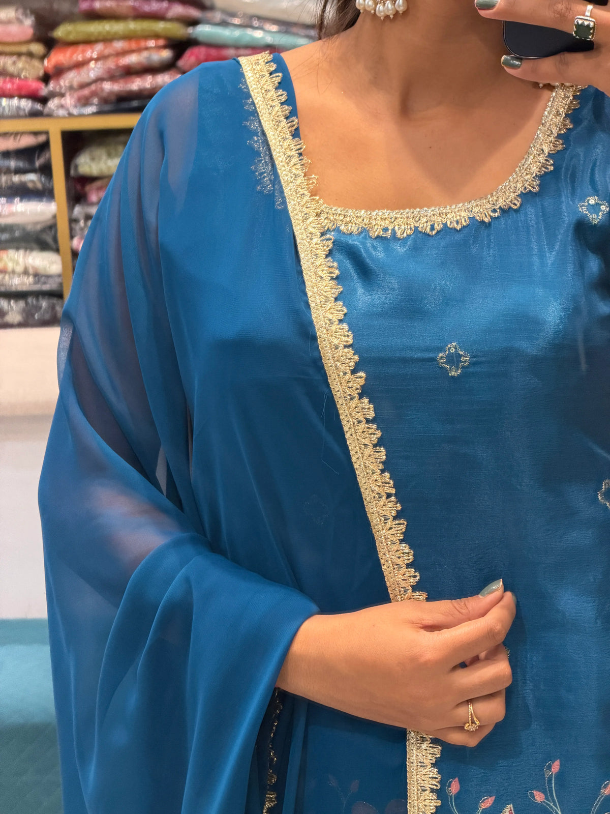 Detailed close-up of neckline lace trim, small sequin bootis, and Chanderi silk texture