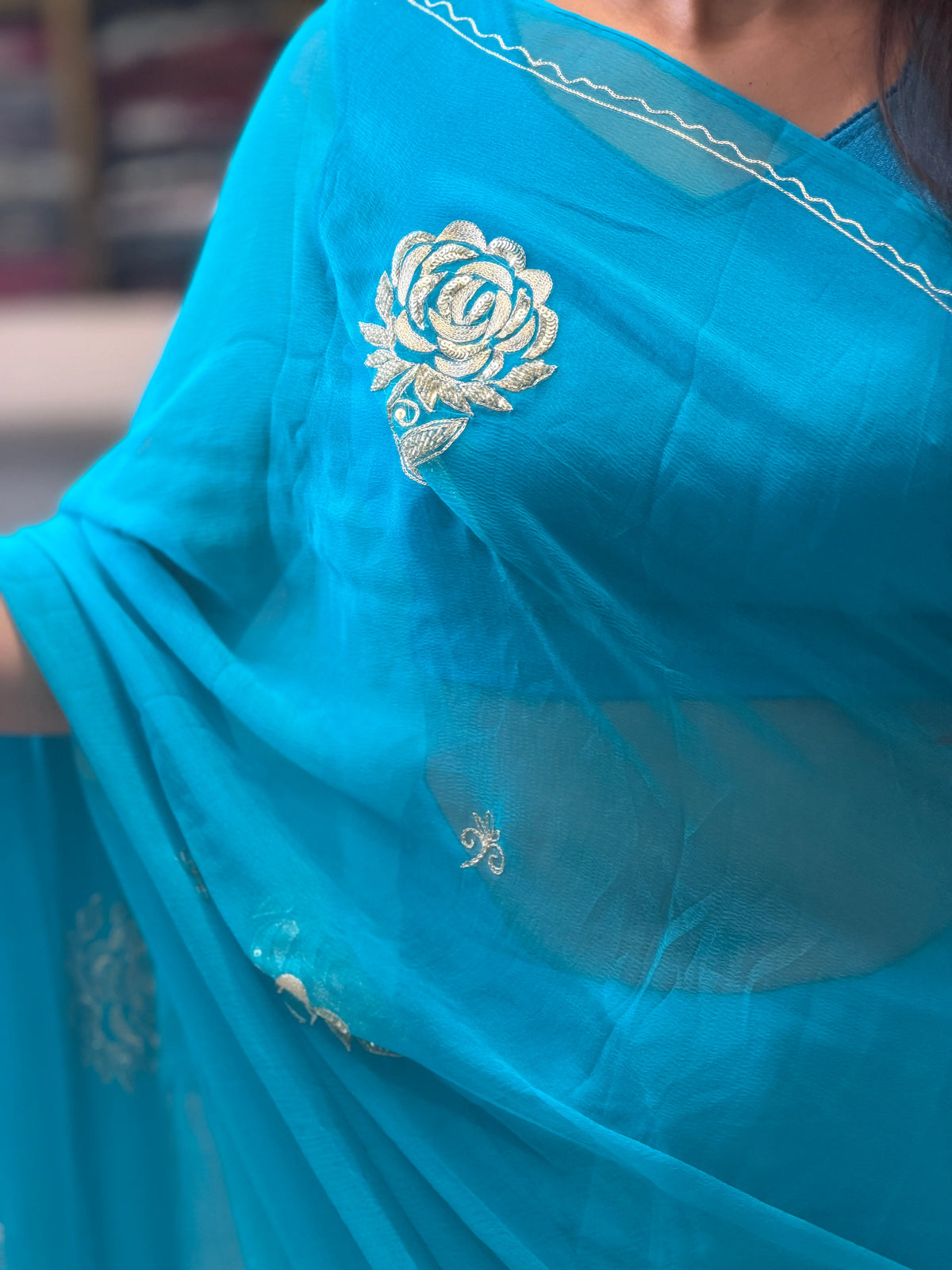 Peacock Blue Pure Chiffon Saree Close-up showing Gold Sequins Pittan Rose Work Motif