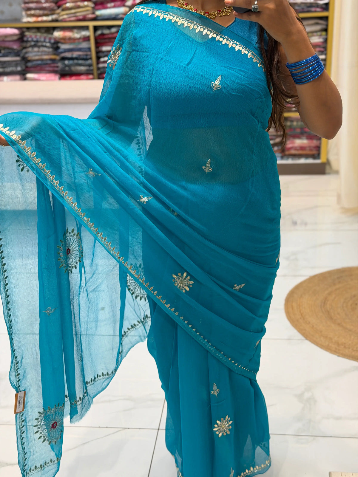 Draped look of Peacock Blue Pure Chiffon Saree with sequin Cut Dana border and sun chakra motifs