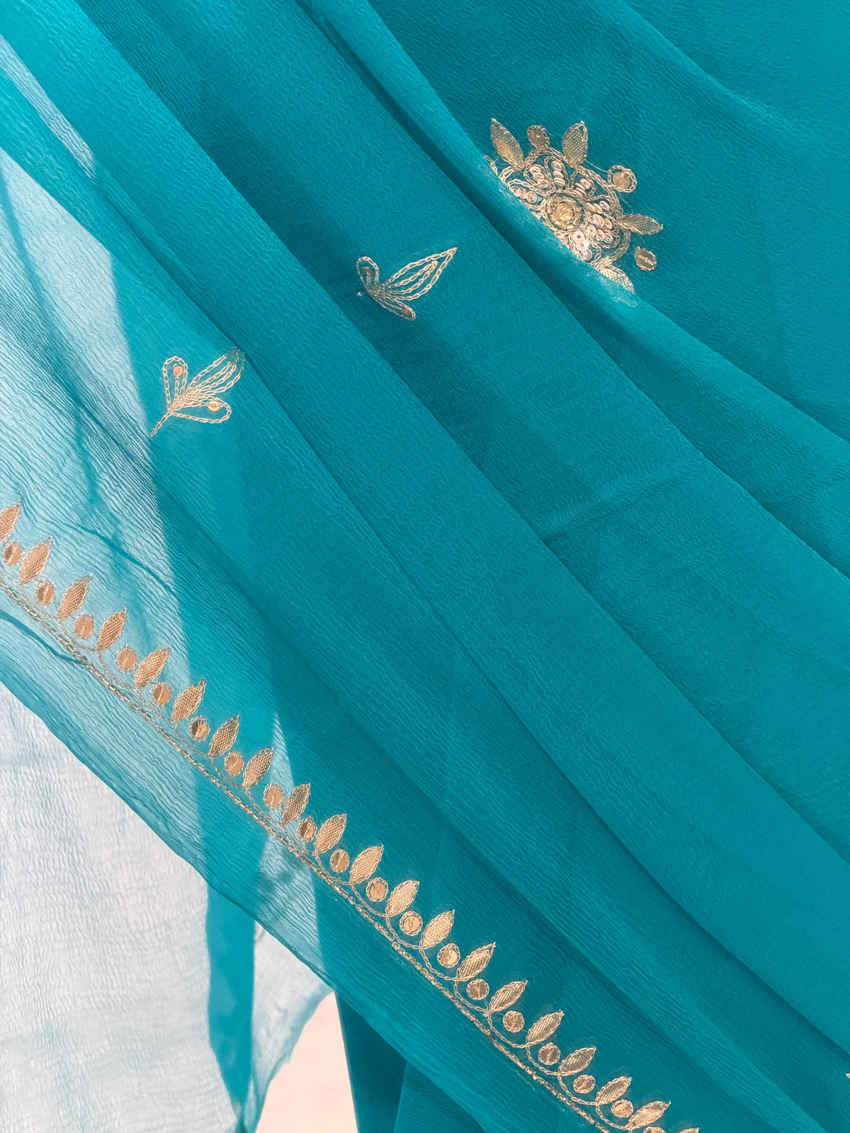 Pallu drape of Peacock Blue Pure Chiffon Saree showing neat Cut Dana border detailing