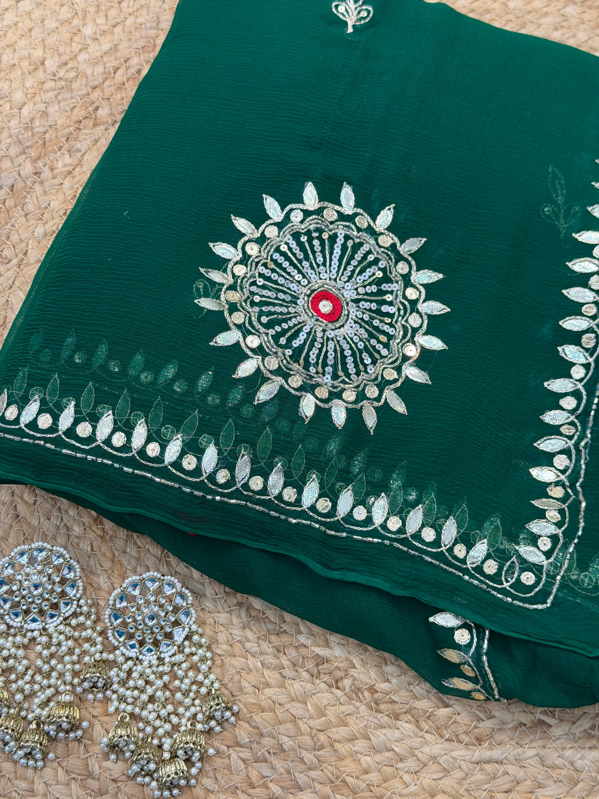 Flat layout of Dark Bottle Green Pure Chiffon Saree with Gota Patti chakra motif and Kundan earrings