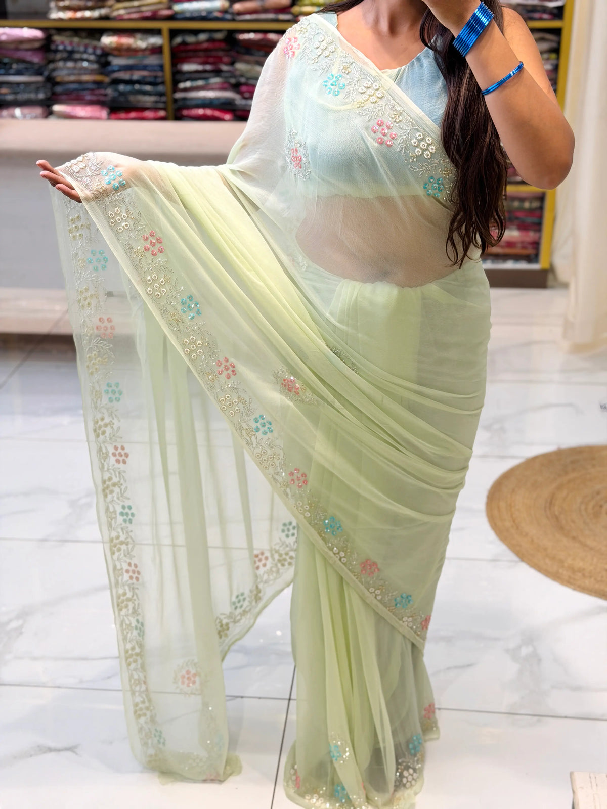 Full draped look of Pastel Pistachio Green Pure Chiffon Saree with embroidered pearl and sequin border