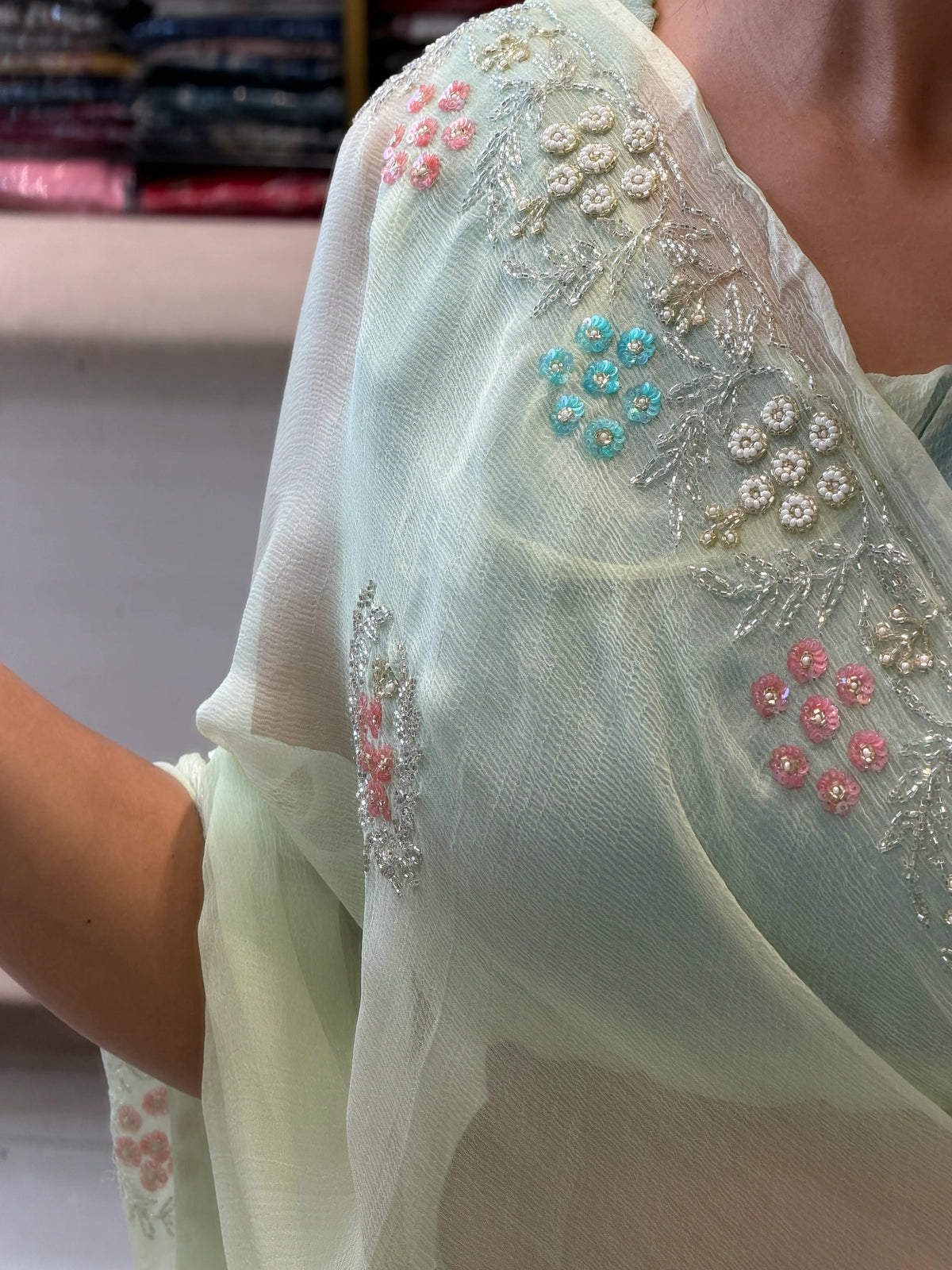 Pallu drape close-up of Mint Green Pure Chiffon Saree showcasing delicate embroidery along the neckline and border
