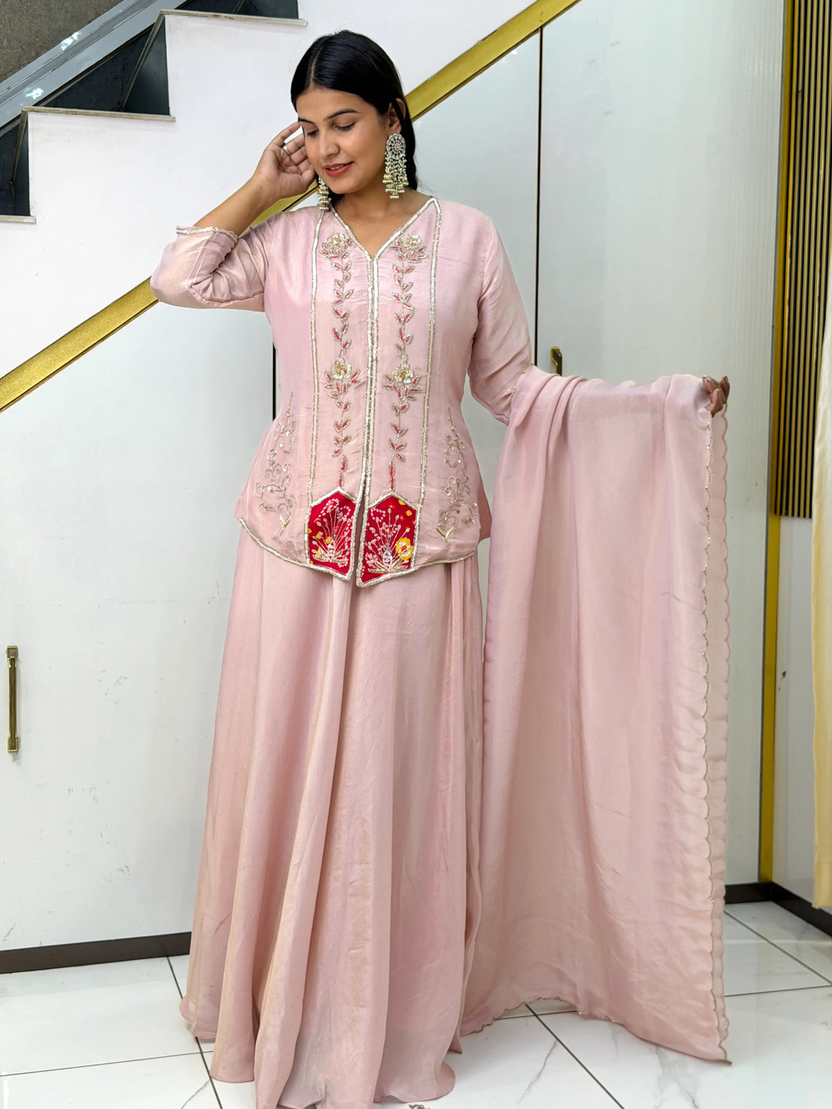 Model in light pink short kurti flared skirt set with scalloped dupatta
